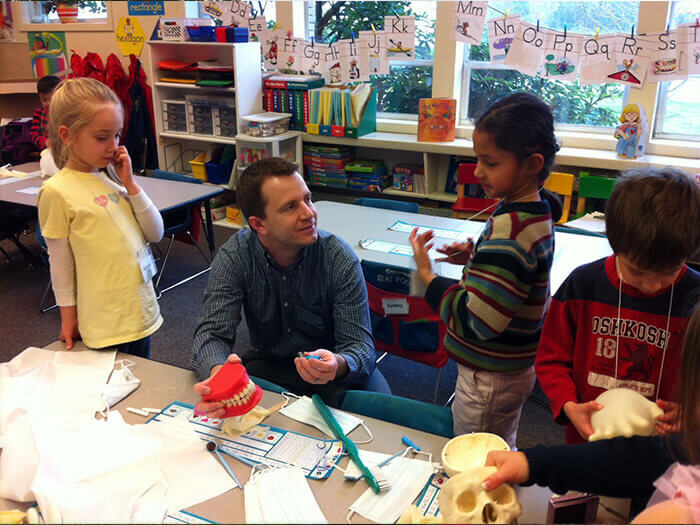 Dr. Brandon Kearbey interacting with children