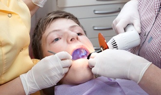 boy receiving treatment from dentist 
