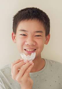 boy holding a mouthguard