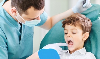 Pediatric dentist in Hillsboro helping a young patient