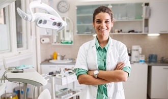 Pediatric dentist in Hillsboro smiling in a dental office