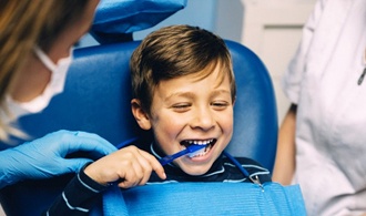 little girl and her mother sitting in the dental chair 