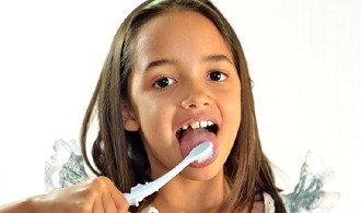 A toddler brushing their teeth.