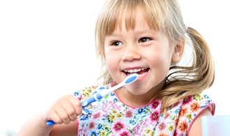 little girl with pigtails brushing her teeth 