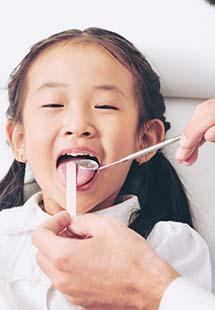 young girl receiving dental checkup