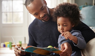 parent reading a book to their child