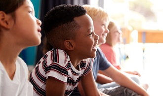 happy child sitting in a classroom