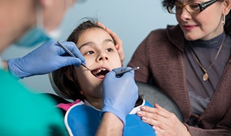 A young girl getting a dental checkup