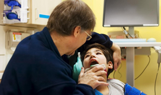Dentist examining child with special needs
