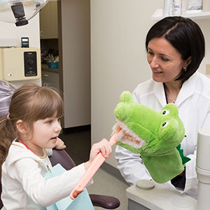 Little girl visiting pediatric dentist