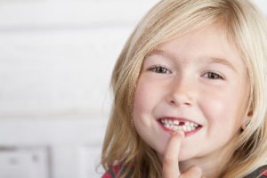 Young girl with missing tooth