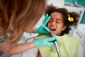 little girl curly hair at dentist