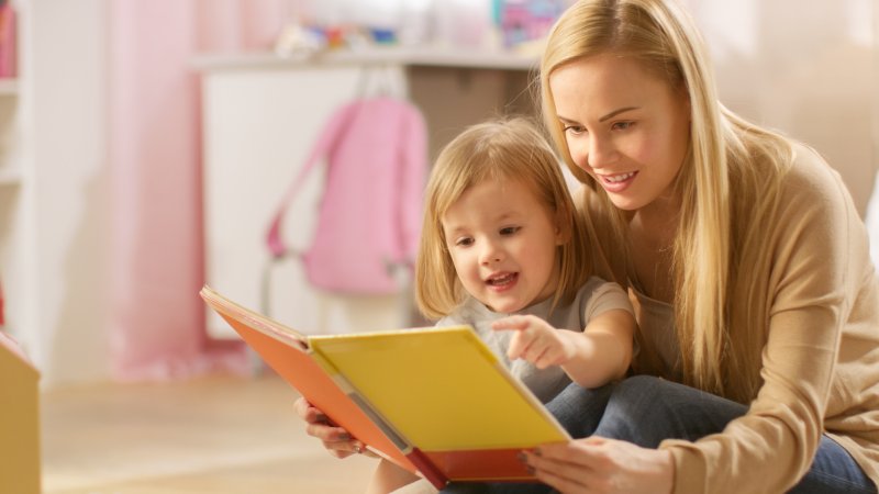 Mother and child reading children's book