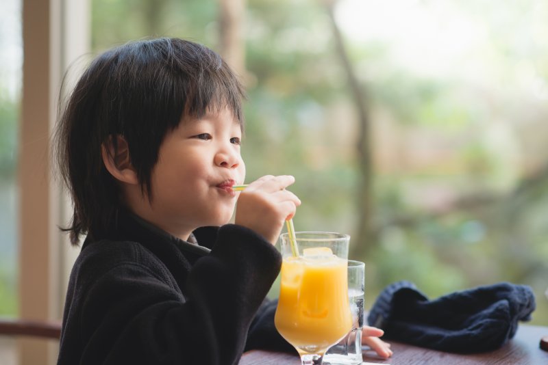 child drinking juice