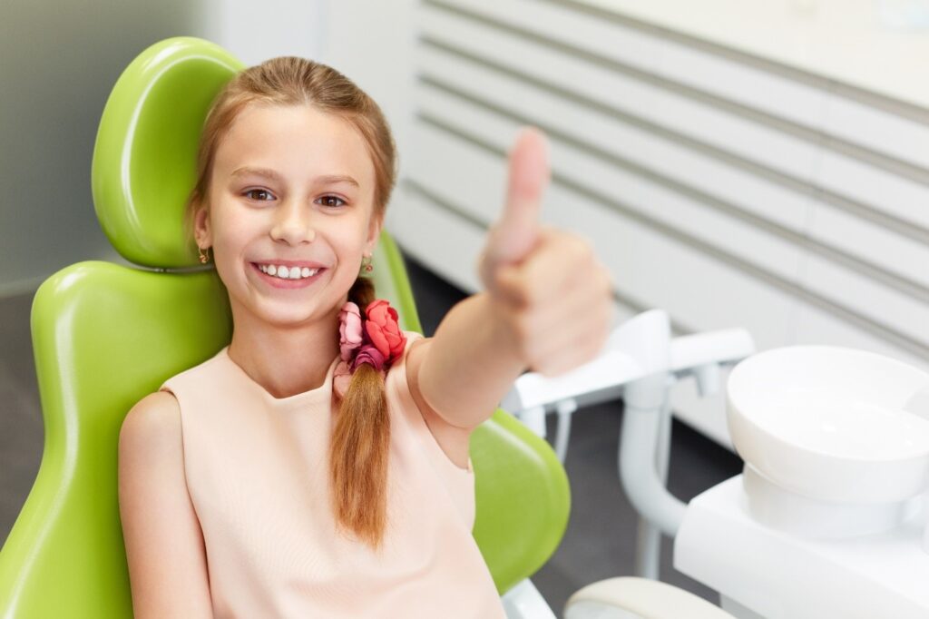 child at dentist smiling